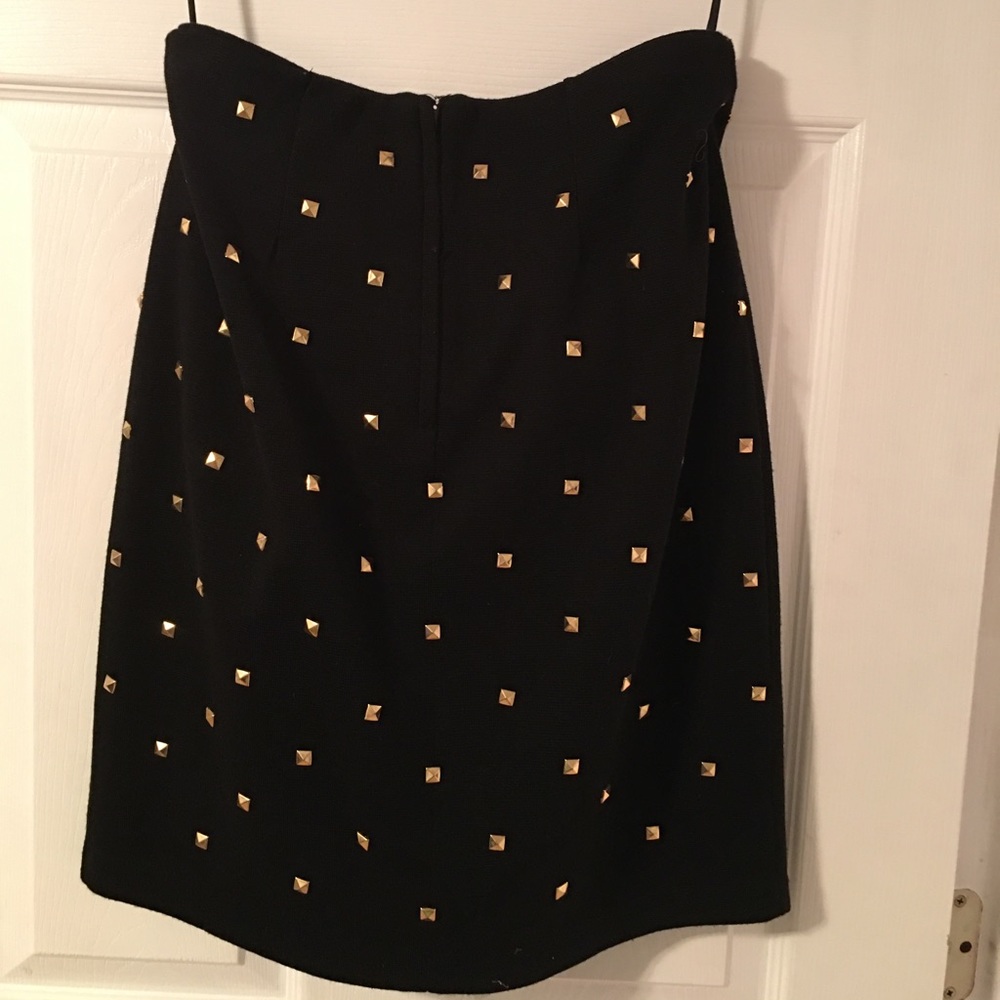 Black stretch knit skirt with all over gold rivets